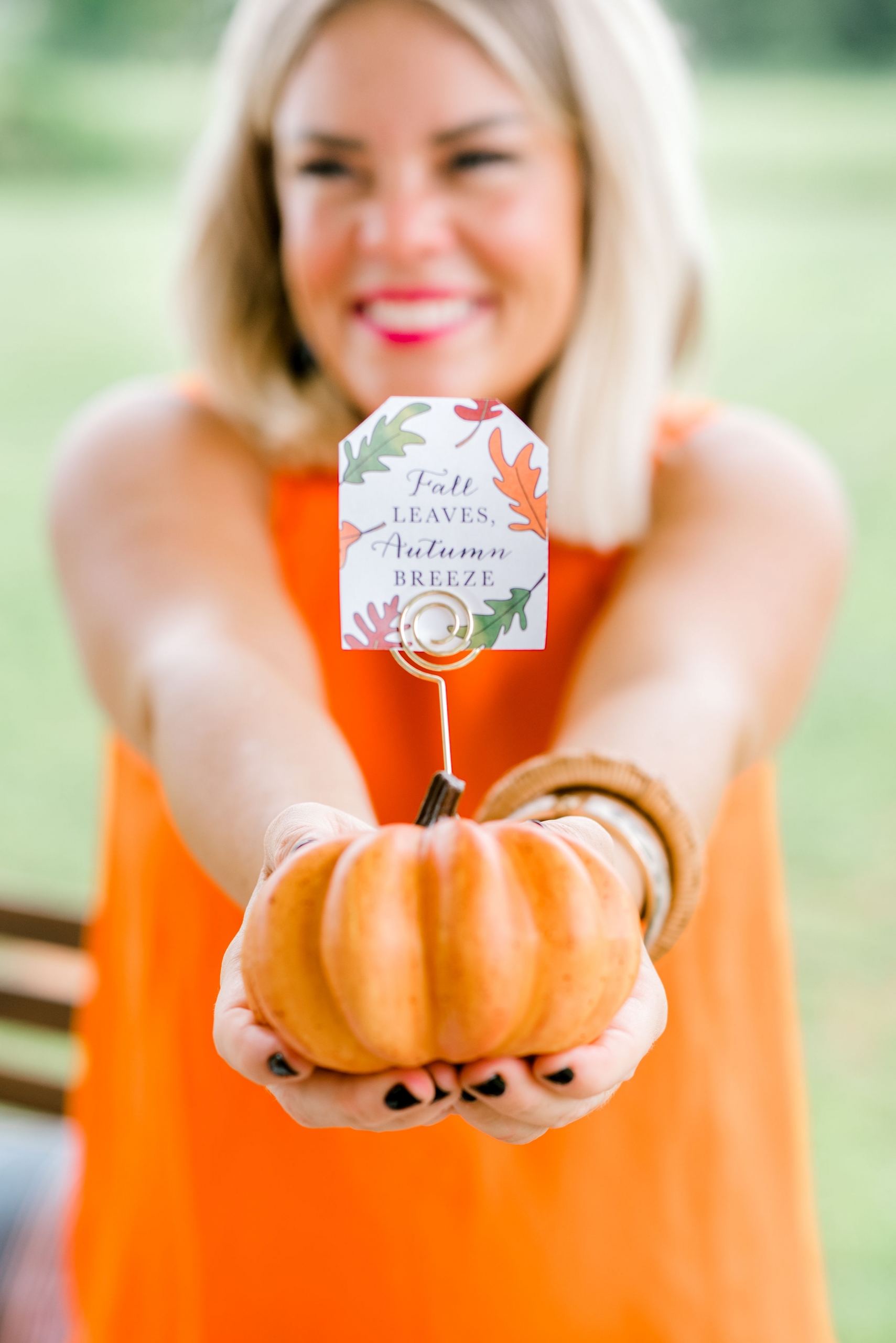 Brittany with place card holder inserted into small pumpkin for fall decor.