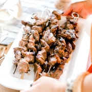 grilled beef kabobs still on serving plate
