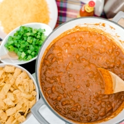 Championship chili with corn chips and green onions.