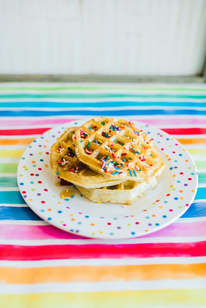 A stack of waffles made special with sprinkles.